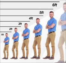 Load image into Gallery viewer, Person in a blue shirt and beige pants standing next to height markers from 1ft to 6ft.